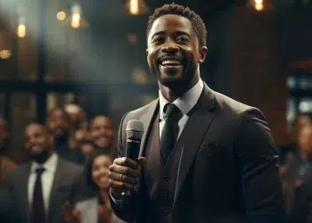 afrikhepri a confident black man speaking in a conference with 2bcce7e3 ff6a 4c68 a9e4 aea15c305070 1
